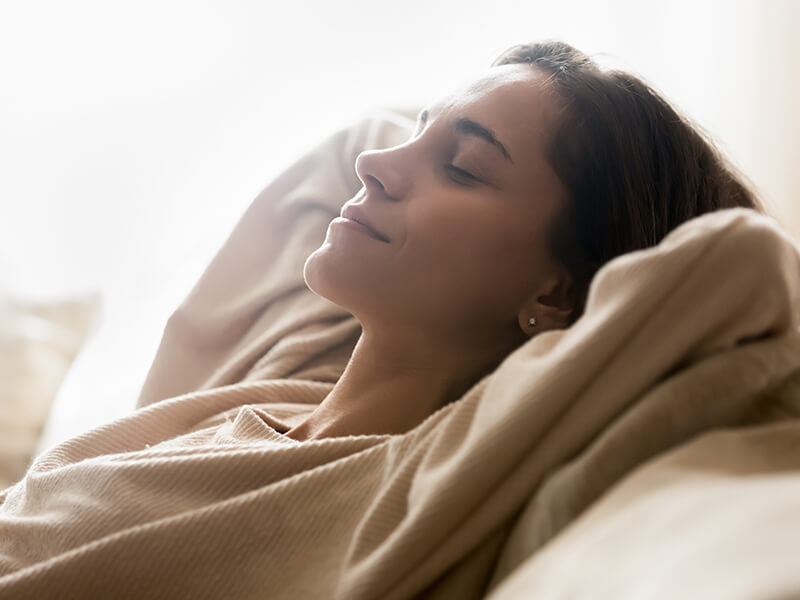 Woman relaxing peacefully on a couch